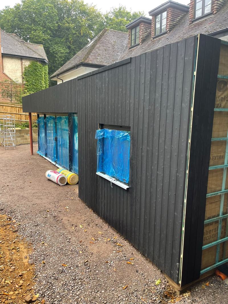 Cladding: The side elevation clad, with the window openings trimmed.