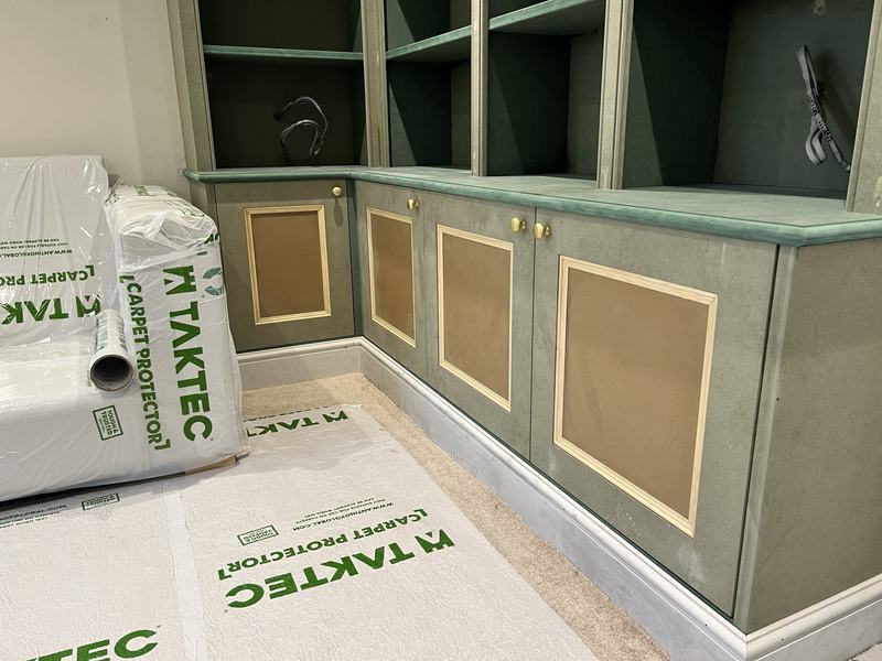 Base cupboards: Panelled cupboards along the base of the second wall.